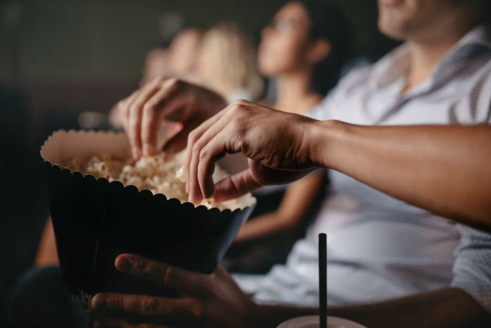 People eating popcorn at the cinema