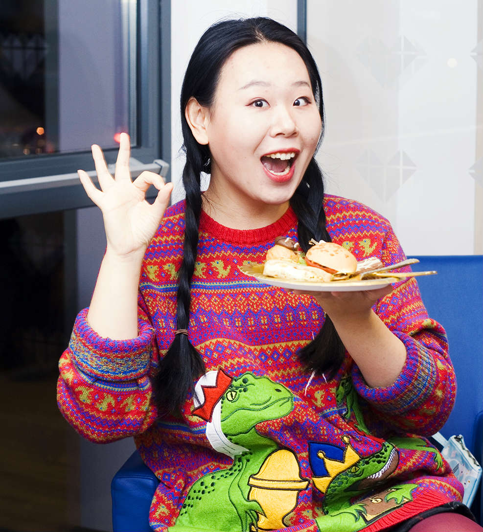 Student enjoying Christmas food at IconInc's Christmas party