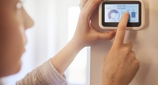 a woman looking at her smart meter