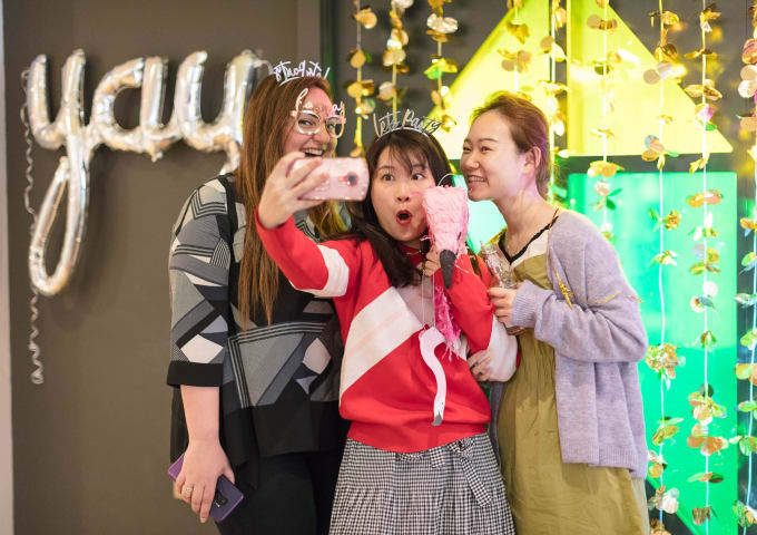 Three students taking a selfie at an IconInc party.